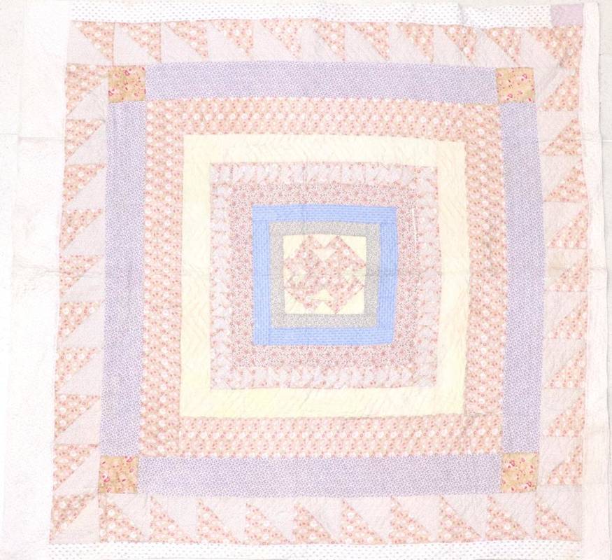 Lot 2018 - Late 19th Century Quilt, with a central geometric design surrounded by frames of floral...