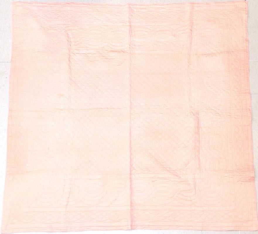 Lot 2019 - A Late 19th Century Pale Pink Cotton Quilt, with cream cotton reverse, quilted with twisted...