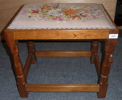 Lot 1657 - A Robert "Mouseman" Thompson Oak Dressing Table Stool, tapestry seat, on four octagonal legs joined