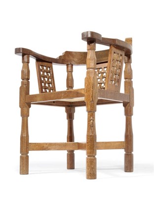 Lot 1660 - A Robert "Mouseman" Thompson Oak Monks Chair, with curved back and shaped arms, over three...