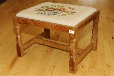 Lot 1671 - A Robert "Mouseman" Thompson Oak Stool, with tapestry seat, on four octagonal legs joined by a...