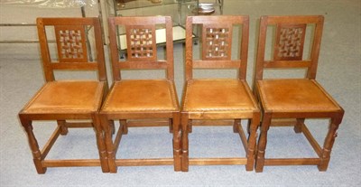 Lot 1677 - A Set of Four Robert "Mouseman" Thompson Oak Lattice Back Chairs, on octagonal front legs,...