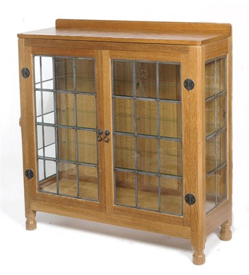 Lot 1682 - A Robert "Mouseman" Thompson Oak Display Cabinet, with raised upstand, above two leaded glazed...