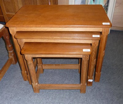 Lot 1686 - A Robert "Mouseman" Thompson Oak Nest of Tables, on four octagonal legs, each with carved mouse...