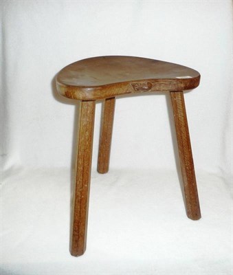 Lot 1687 - A Robert "Mouseman" Thompson Oak Cow Kidney Stool, on three tapered octagonal legs, with carved...