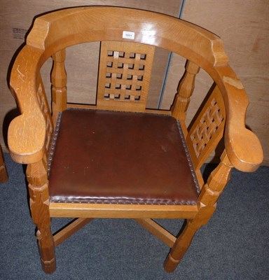 Lot 1691 - A Robert "Mouseman" Thompson Oak Monks Chair, with curved back and shaped arms over three...