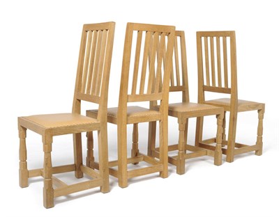 Lot 1696 - A Set of Four Robert "Mouseman" Thompson Millennium Range Oak Dining Chairs, with curved back above