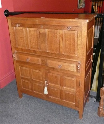 Lot 1700 - A Colin "Beaverman" Almack Oak Panelled Bureau, the fall front with two rests carved with a beaver