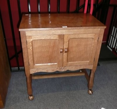 Lot 1720 - A Yorkshire Oak Record Cabinet, with two cupboard doors opening to reveal a fitted interior, on...