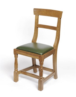 Lot 1732 - A Squirrel Woodcarvers English Oak Child's Chair, with shaped rail back, drop-in green leather...