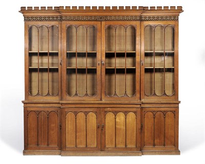 Lot 1741 - An Oak Ecclesiastical Breakfront Bookcase, late 19th century, the bold dentil cornice above a...