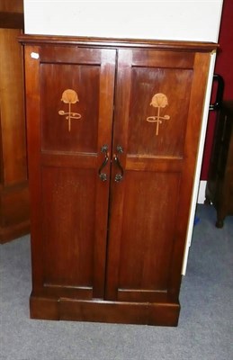 Lot 1749 - An Art Nouveau Inlaid Mahogany "The Autovalet", the two doors inlaid with stylised flowers...