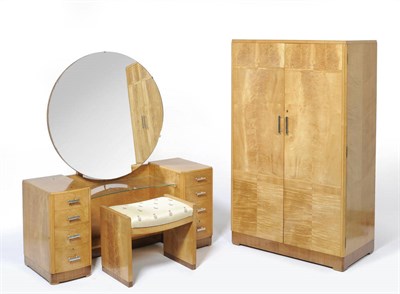 Lot 1750 - An Art Deco Heal's Satinwood Bedroom Suite, comprising triple door wardrobe with fitted...