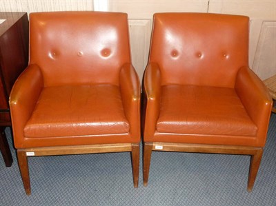 Lot 1772 - A Pair of Jens Rison Armchairs, upholstered in orange leather on a teak frame, labelled "Jens Rison