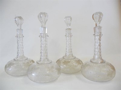 Lot 3 - A Set of Four Victorian Engraved and Slice Cut Shaft and Globe Decanters and Stoppers, circa...