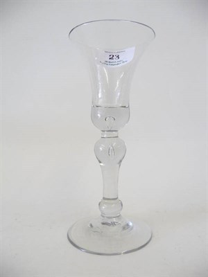 Lot 23 - A Wine Glass, circa 1730, the bell bowl with tear drop to the solid base, on a  baluster stem...