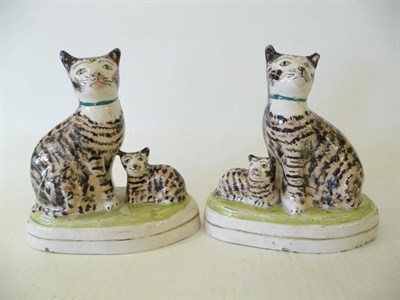 Lot 82 - A Pair of Staffordshire Pottery Cat and Kitten Groups, 19th century, the mother cats seated on...