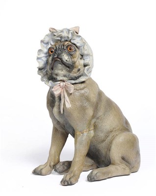 Lot 148 - An Austrian Polychrome Painted Terracotta Model of a Seated Pug, circa 1910, wearing a frilled blue