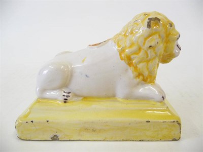 Lot 156 - A French Faience Lion Inkwell, 19th century, the recumbent male lion with well defined mane and...