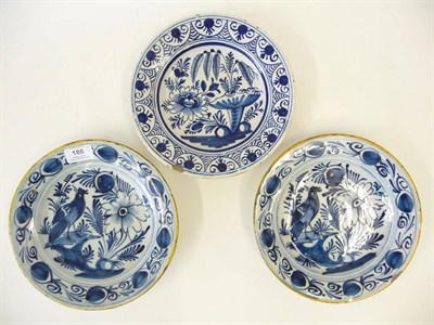 Lot 186 - A Pair of Dutch Delft Blue and White Pottery Plates, circa 1750, circular, with mustard painted...