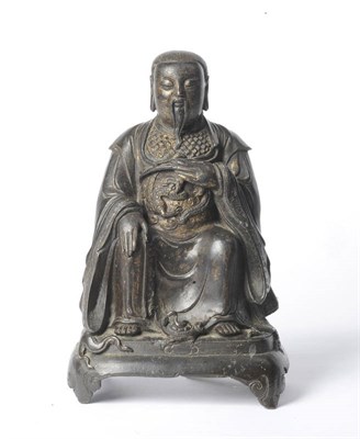 Lot 223 - A Chinese Parcel Gilt Bronze Figure of Guandi, possibly late Ming, seated in forward gaze, enrobed