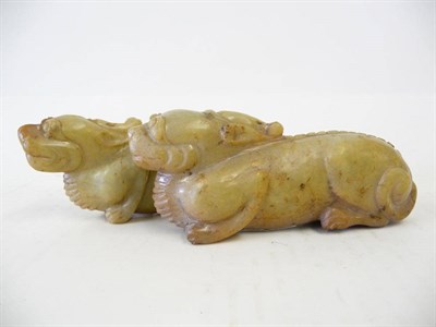 Lot 235 - A Pair of Chinese Carved Soapstone Figures of Crouching Dragons, 20th century, each of stylised...