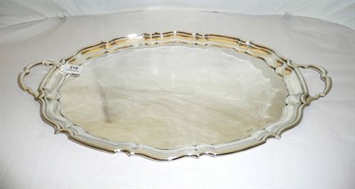 Lot 319 - A George V Tray, Cooper Bros, Sheffield 1925, shaped oval with twin loop handles, 54.5cm long, 44oz