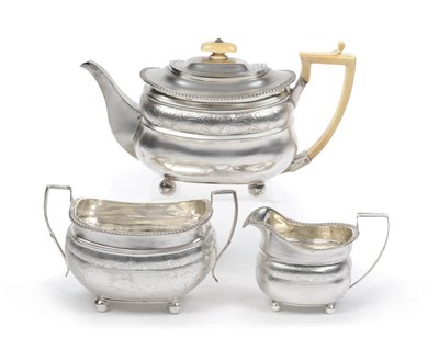 Lot 367 - A George III Three Piece Teaset, Solomon Hougham, London 1811, of oblong form on four ball feet...