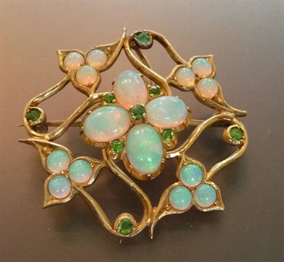 Lot 427 - An Art Nouveau Opal and Demantoid Garnet Brooch, a cluster of four oval cabochon opals and...