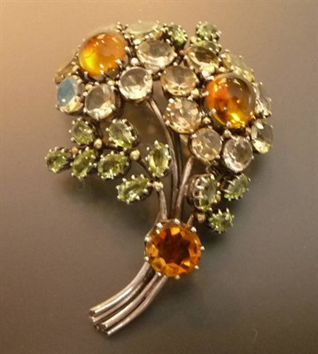 Lot 430 - An Arts and Crafts Floral Brooch, by Dorrie Nossiter, set with peridot and topaz throughout, in the