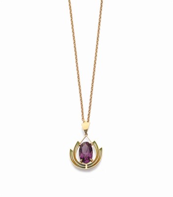 Lot 433 - An Art Nouveau Amethyst and Plique-à-Jour Pendant, the oval cut amethyst within a curved frame...