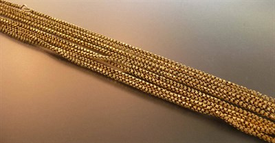 Lot 441 - A Yellow Metal Long Guard Chain, fancy links of textured form linked by a pair of rings, length...