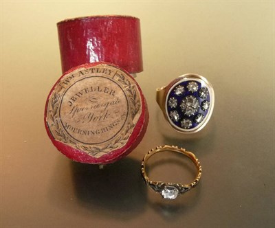 Lot 460 - A Diamond and Enamel Mourning Ring, rose cut diamonds in old claw settings in a spaced cluster on a