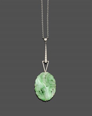 Lot 488 - A Jade Necklace, an oval pierced and carved jade panel in white claw settings is suspended from...