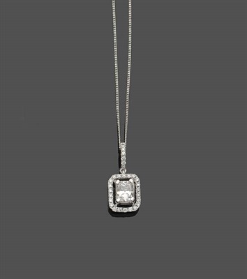 Lot 489 - A Diamond Cluster Pendant on a Chain, a radiant cut diamond sits within a frame of round...