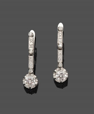 Lot 490 - A Pair of Diamond Drop Earrings, a round brilliant cut diamond in a white chunky old style claw...