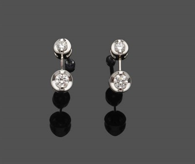 Lot 491 - A Pair of 18 Carat White Gold Diamond Drop Earrings, a round brilliant cut diamond suspends another