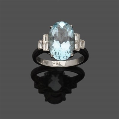 Lot 494 - An Aquamarine and Diamond Ring, the oval mixed cut aquamarine flanked by a tier of three...