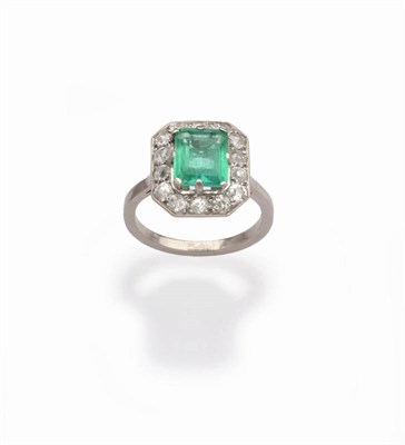 Lot 501 - An Art Deco Emerald and Diamond Cluster Ring, the emerald-cut emerald in a white claw setting...