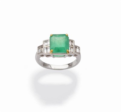 Lot 502 - An Emerald and Diamond Ring, an octagonal step cut emerald in a yellow four claw setting,...