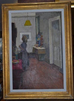 Lot 1155 - British School (20th century) Interior scene with a girl standing under a yellow lamp shade...