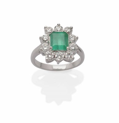 Lot 511 - An Emerald and Diamond Cluster Ring, the emerald-cut emerald within a border of round brilliant cut