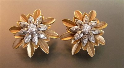 Lot 512 - A Pair of 18 Carat Gold Diamond Cluster Earrings, a round brilliant cut diamond sits within...