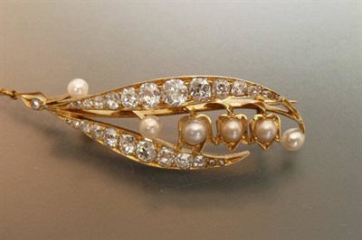 Lot 514 - A Diamond and Split Pearl Leaf Brooch, two leaves set with graduated old mine cut diamonds are...