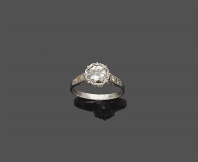 Lot 525 - A Diamond Solitaire Ring, with diamond set shoulders, a round brilliant cut diamond in a claw...