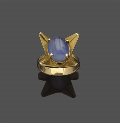 Lot 526 - A Star Sapphire Ring, the oval cabochon blue star sapphire in a four claw setting, within a...