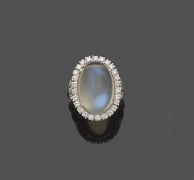 Lot 528 - An 18 Carat White Gold Moonstone and Diamond Cluster Ring, the oval cabochon moonstone within a...