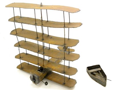 Lot 1225 - Phill Hopkins (Contemporary) A multi winged aeroplane with a ladder Oxidised metal, together with a