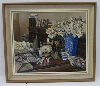 Lot 1253 - Marion Bradley (b.1946)  Interior scene with a vase of flowers and a sewing machine Signed and...