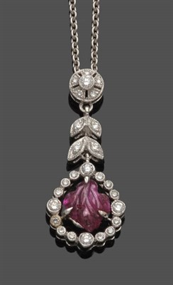 Lot 538 - A Ruby and Diamond Pendant on Chain, the ruby carved in the form of a leaf, within a diamond frame